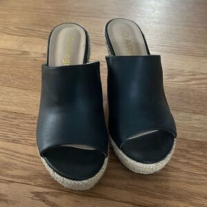 Beautiful black wedges. Size 7.5 worn once. Great buy! No issues!